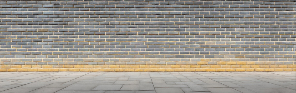 Gray brick wall yellow brick base empty pavement outdoor fence urban texture wide panoramic view of long outdoor gray golden brick fence clean background masonry pattern