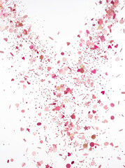 Naklejka premium Pink confetti exploding in air with hearts and stars on white background