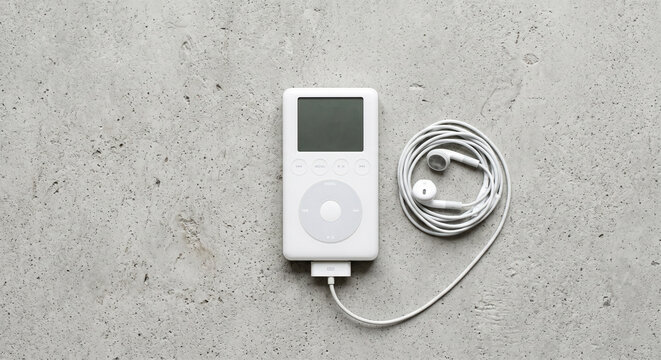 Player Classic with Earbuds Flatlay on Concrete Background Retro 2000s Music Player Nostalgia