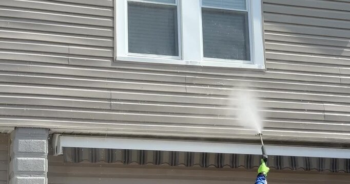 Power Washing siding of house and window