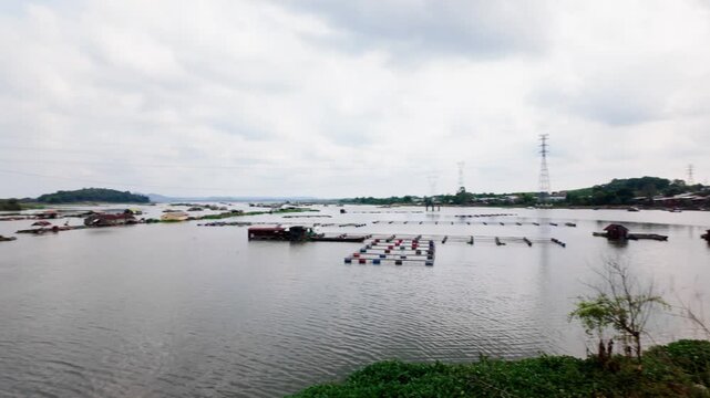 Watch as boats move around the water near La Nga Bridge. Observe the simple scenery and everyday life of the people in the area. Discover this part of Vietnam during daylight.