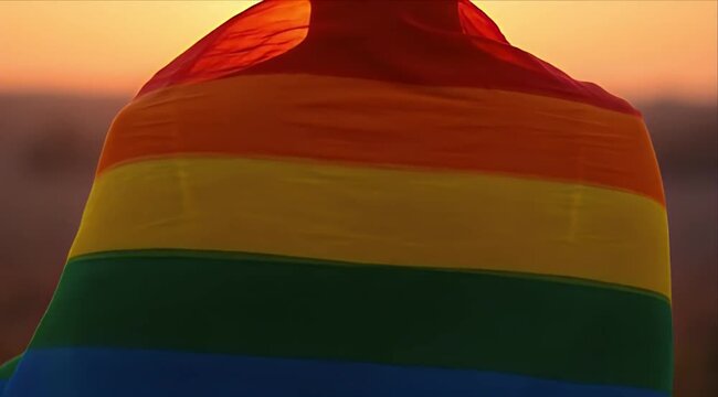 Pride month Rainbow flag pride lgbt equality freedom sunset silhouette colorful fabric banner wrapped with glowing hope dusk symbol of love diversity and human right peaceful outdoor landscape