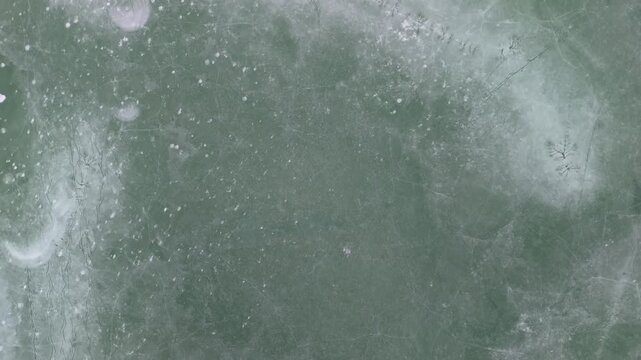 In the Ko&scaron;ice Region of Slovakia, the frozen Ruž&iacute;n reservoir near Mal&yacute; Folkmar shows cracked ice patterns across its icy surface during winter from a top down drone view.
