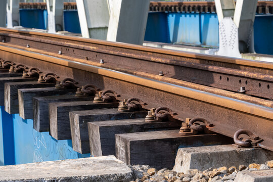 A close-up view of the structural steel framework and railway tracks of the historical Renville bridge in Kebumen, Central Java, Indonesia.