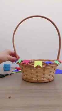 Preparation for Festa Junina - Decorating the wicker basket with mini colorful flags