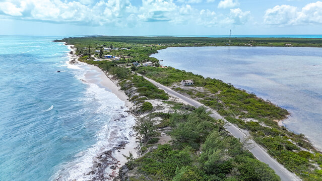 Aerial view of the historic salt trading post on a narrow coastal strip between the turquoise ocean and a calm lagoon in Exuma, Exuma, The Bahamas.