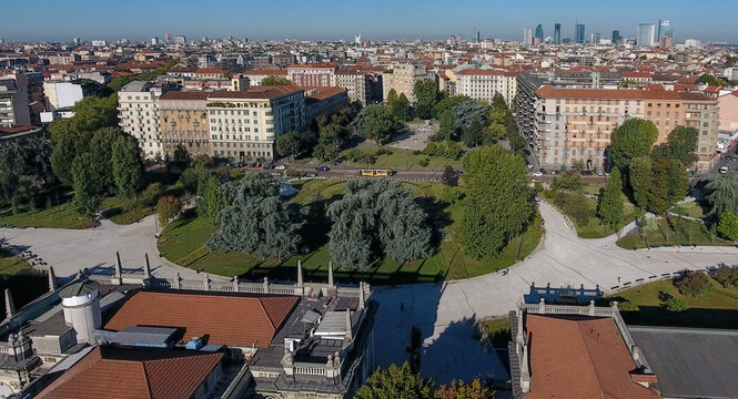 Aerial view of the Politecnico di Milano campus and Piazza Leonardo da Vinci with historic buildings, lush green trees, and the modern city skyline in Milano, Lombardia, Italy.