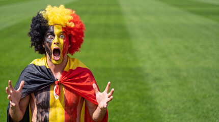 Obraz premium Belgian Soccer Fan Shouting With Arms Outstretched