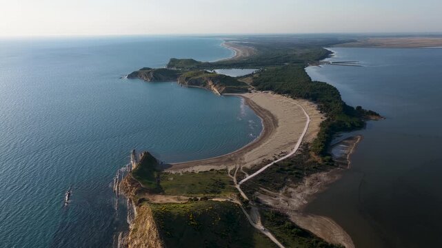 Aerial view of the sandy coastline and lush pine forest separating the sea from Narta Lagoon in Zvernec, Vlore County, Albania.