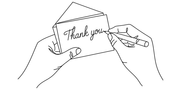 Hands writing a thank you note on a folded card