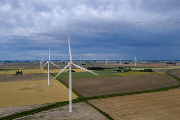 Fototapeta premium Dramatic Aerial View of Ohio Wind Farm Beneath Approaching Severe Storm Clouds Over Antwerp