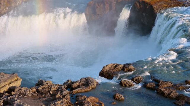 Aerial view of Powerful waterfall Godafoss pouring into a rocky basin. Iceland