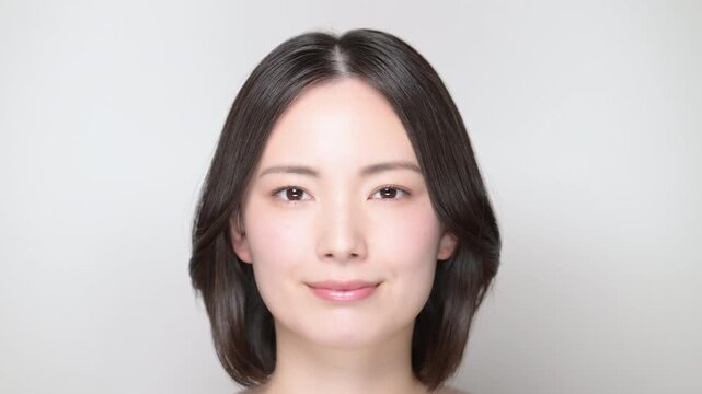 A video showcasing the beautiful expression and natural beauty of a young woman slowly opening her eyes from the front, along with skincare tips, etc.