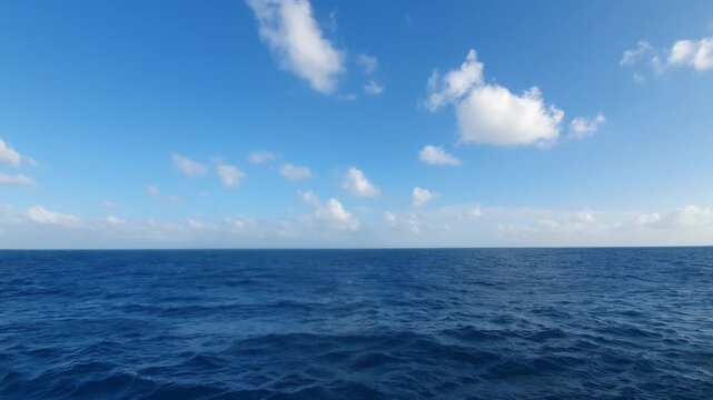 various shapes of clouds in the sky above the choppy sea