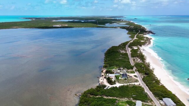 Aerial view of the narrow coastline featuring the historic salt trading post, turquoise waters, and lush vegetation in Exuma, Exuma, The Bahamas.