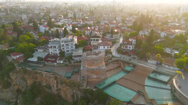 Antalya, Turkey. Hidirlik Tower, a cylindrical Roman stone structure on a square base, aerial view at sunrise over Kaleici Old Town and the Mediterranean cliff edge. Aerial View, Departure of the cam