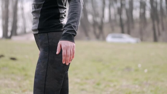 Athlete performing leg stretching exercises including hamstring pull, quadriceps hold, calf press, and hip flexor opener during warmup routine on track field