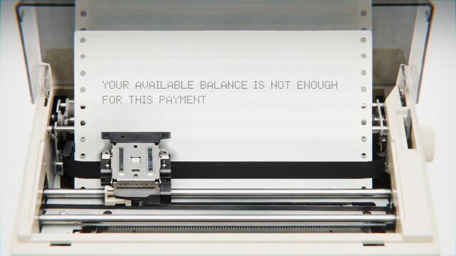 Old Dot Matrix Printer Printing YOUR AVAILABLE BALANCE IS NOT ENOUGH FOR THIS PAYMENT Text on continuous white paper Close Up view.
