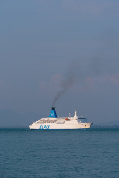 PENANG, MALAYSIA - MAR 19, 2026: Wide view of Elpis passenger ferry sailing across calm sea with blue sky and distant coastline.