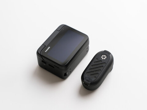 PENANG, MALAYSIA - MAY 28, 2025: The Insta360 GO 3S tiny camera module placed next to its Action Pod housing showing magnetic connection pins.