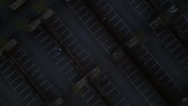 large car parking lots at a outlet center in winter. Smooth aerial view drone