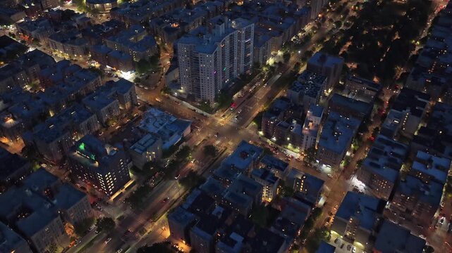 Urban landscape showing residential district in South Bronx, New York at night with illuminated streets, moving traffic, urban living and modern architecture concepts