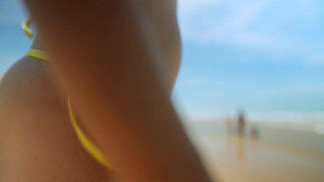 Woman in green bikini on sunny beach