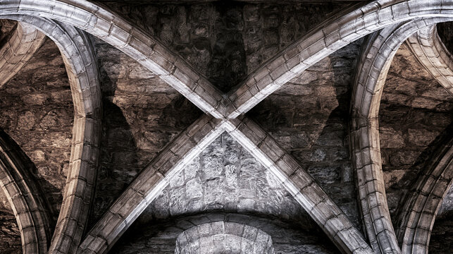 groin. Intersecting stone arches of a Gothic cathedral ceiling meeting at a precise groin vault. real-estate listings.