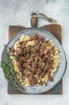 Turkish kavurma over pilaf showing browned fibers, maillard crust, collagen rich shredded meat and detailed macro texture on ceramic plate.