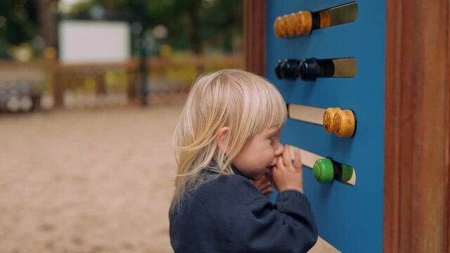 White blond toddler masters activity board playful problem solver