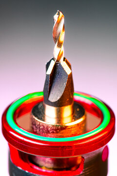 Engineering Series : High angle view shows premium countersink drill bit set on creative neon cyberpunk background.