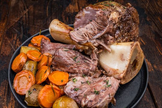 Braised Slow cooked beef osso buco with juicy meat texture marrow bone and roasted vegetables top view
