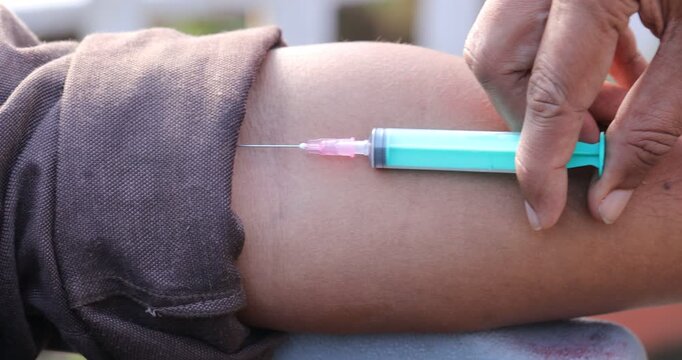 Doctor hand with injection