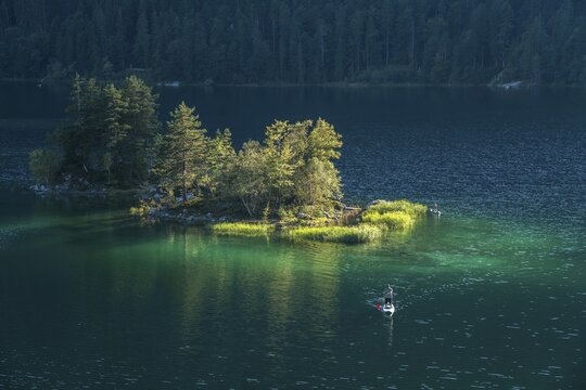 Island in Eibsee lake below the Zugspitze in the Wetterstein range in Grainau, Bavaria, Germany