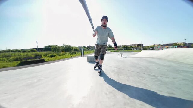 Energetic fit man inline skating fast at Doughiska Skatepark in Galway performing smooth tricks, dynamic movements, urban fitness and action sports