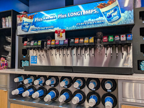 Quebec, Canada, 24 April 2026 : A self-serve soda fountain machine offers various soft drinks including Coca-Cola, Pepsi,  Up, and Polar Pop.