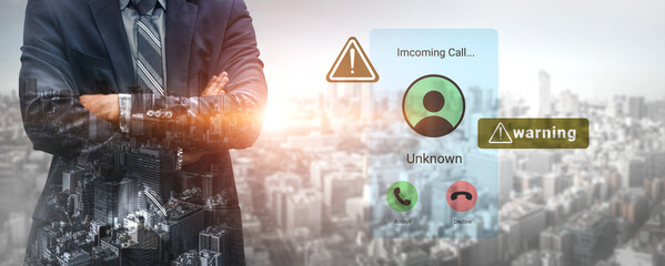 A businessman stands confidently with crossed arms, facing a digital screen showing an incoming call from an unknown number, accompanied by warning symbols against a vibrant city backdrop. Gantry © InfiniteFlow