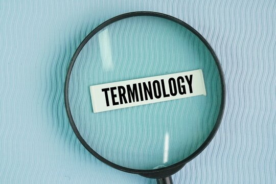 magnifying glass with the word TERMINOLOGY. a group of specialized words and respective meanings in a particular field, and also the study of such terms and their use
