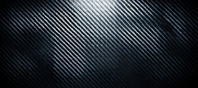 Diagonal textured surface with a carbon fiber-like appearance, a subtle gradient of light to dark, creating a sense of depth and dimension