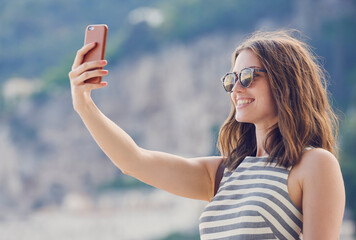 Holiday, selfie and smile of woman outdoor in sunglasses for travel or vacation in summer. Break, photograph and shades with happy tourist in nature for memories, social media picture or update