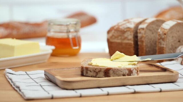 Butter spreading on fresh bread slice, close up homemade breakfast scene, copy space