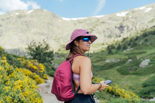 Woman with backpack hiking in the mountains