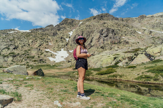 Happy young woman hiking in a mountain landscape