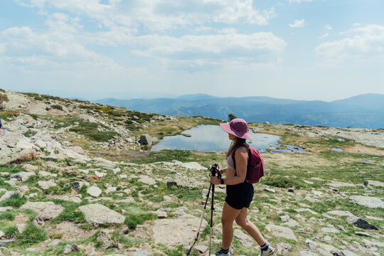 Woman hiking on a rocky mountain trail