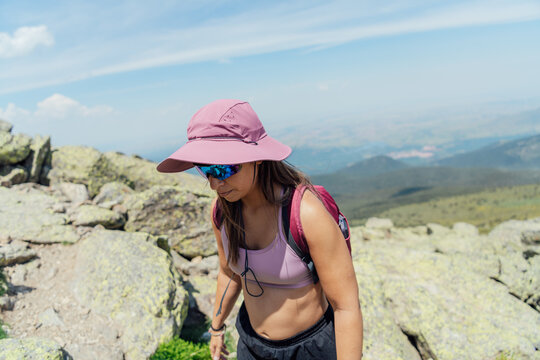 Active woman hikes on a rocky mountain path