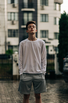 Teenage boy with confident gaze standing outdoors