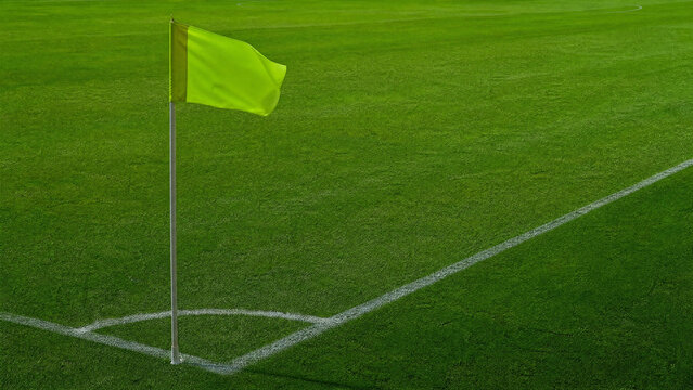 Dynamic shot of a red corner flag fluttering on a green turf field, providing a sense of motion and excitement at a professional soccer stadium during an intense championship football match.
