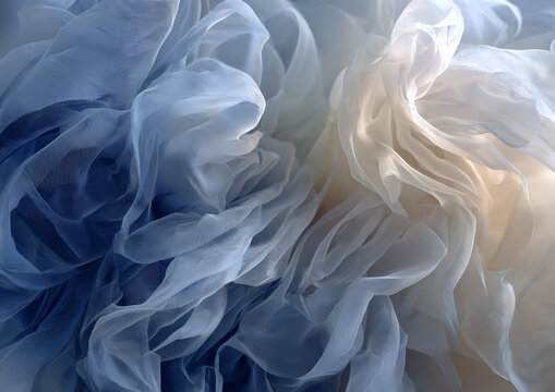 Soft, flowing fabric in shades of blue and cream creates an abstract composition. Light and shadow interplay. Gentle, airy, elegant