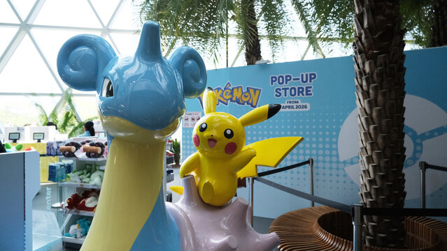 Singapore on 14 April 2026: Inside of Pokemon Center in Jewel Changi, displays of Pok&eacute;mon plush toys and merchandise on sale at Pokemon Center Singapore. cute statue of Pikachu riding the Lapras