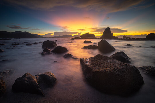 Dramatic Sunset at Papuma Beach with Rocky Sea Stacks, Jember, East Java Indonesia